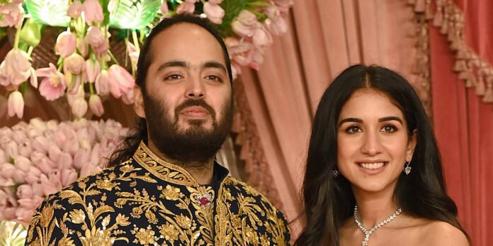 In this photo provided by Reliance Industries, Anant Ambani (L), the son of billionaire Mukesh Ambani, holds hands with Radhika Merchant during their wedding ceremony at the Jio World Convention Centre in Mumbai, India, Friday, July 12, 2024. (Reliance Industries via AP)