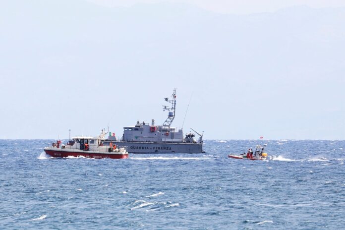 Emergency services at the scene of the search for a missing boat, in Porticello Santa Flavia, Italy, Monday, Aug. 19, 2024. British tech giant Mike Lynch, his lawyer and four other people are among those missing after their luxury superyacht sank during a freak storm off Sicily, Italy’s civil protection and authorities said. Lynch’s wife and 14 other people survived. (Alberto Lo Bianco /LaPresse via AP).