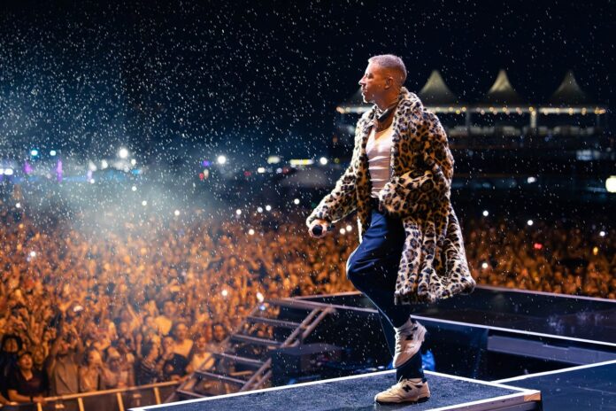 A fan experienced was arrested on stage while performing with rapper Macklemore at a festival because of an outstanding arrest warrant.