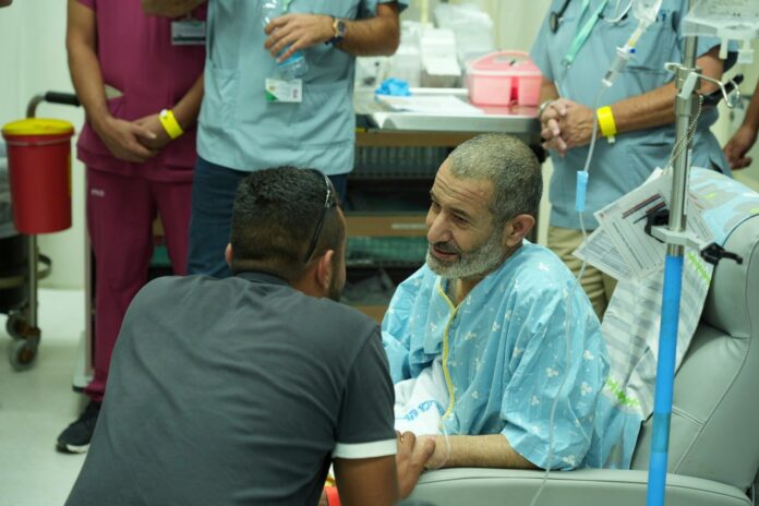 In this photo released by the Israel Prime Minister Office on Tuesday, Aug. 27, 2024, Qaid Farhan Alkadi, 52, who was held hostage by Hamas militants in Gaza sits in a room at the Soroka Medical Center in Beersheba, Israel. (Israel Prime Minister Office via AP).