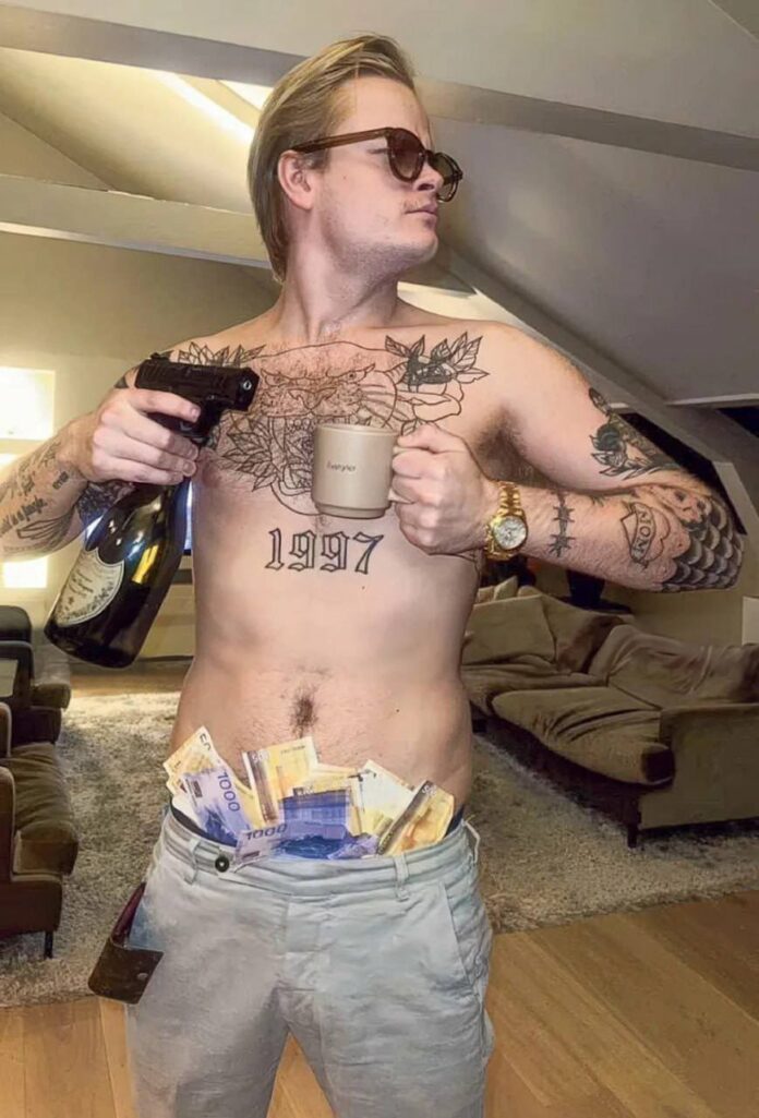 PHOTO: Marius Borg Høiby holding a gun with stack of money in his pants