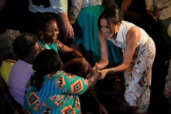 Meghan Markle, Prince Harry's wife, greets people during forum on Afro women and power in Cali, Colombia, Sunday, Aug. 18, 2024. (AP Photo/Ivan Valencia).