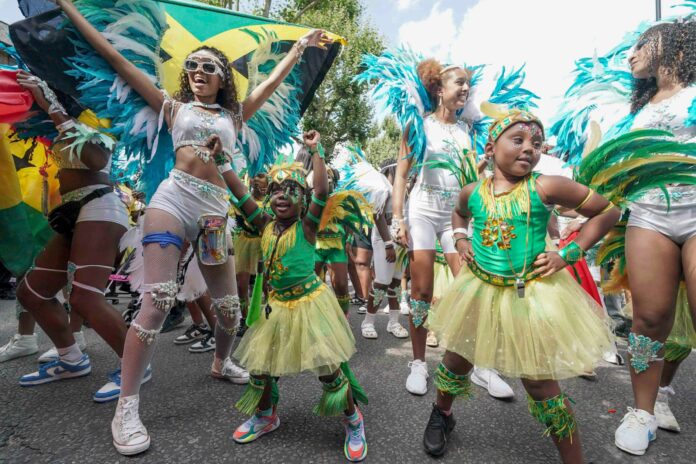 Participants taking part in the Children's Day Parade, part of the Notting Hill Carnival celebration in west London, Sunday, Aug. 25, 2024. (Jeff Moore/PA via AP).