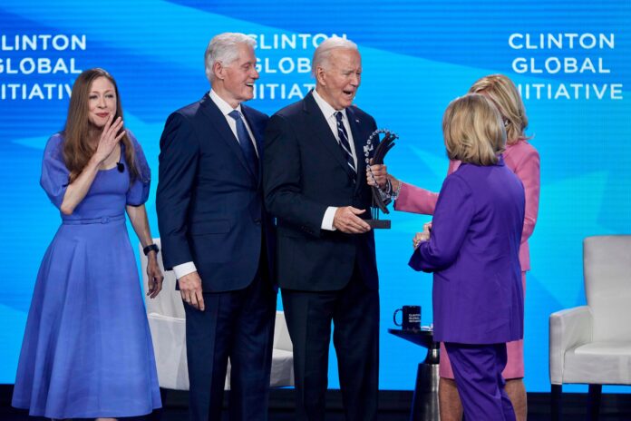 Biden praises Clintons at Global Initiative summit