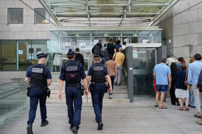 Police officers walk in the Avignon court house prior to the trial of Dominique Pelicot, in Avignon, southern France, Thursday, Sept. 5, 2024. (AP Photo/Lewis Joly, File).