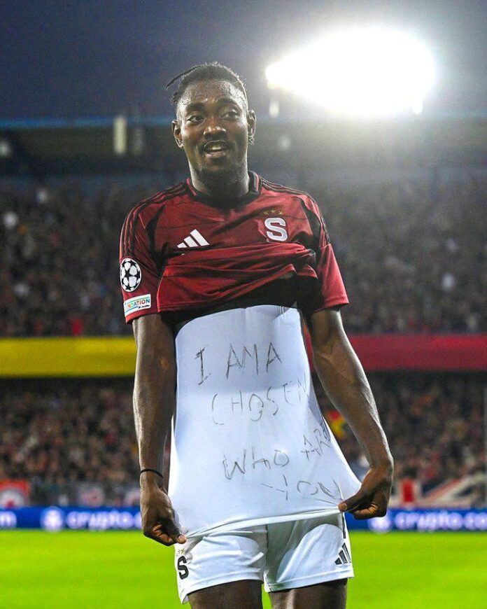 PHOTO: Victor Olatunji joined I Am A Chosen, Who Are You TikTok Challenge as he showed off his tshirt to celebrate goal scored