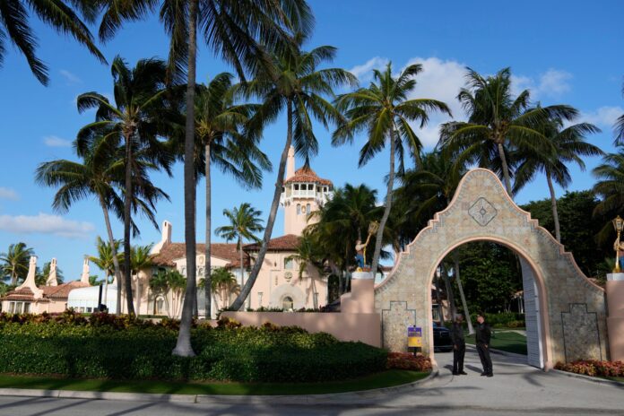 Security agents talk at the entrance to former President Donald Trump's Mar-a-Lago estate, March 31, 2023, in Palm Beach, Fla. (AP Photo/Rebecca Blackwell, File).