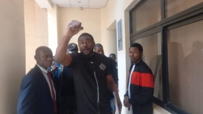 VIDEO: Pidom blogger, Bristol Isaac Tamunoibifiri, coughing while holding his chest as he left the courtroom